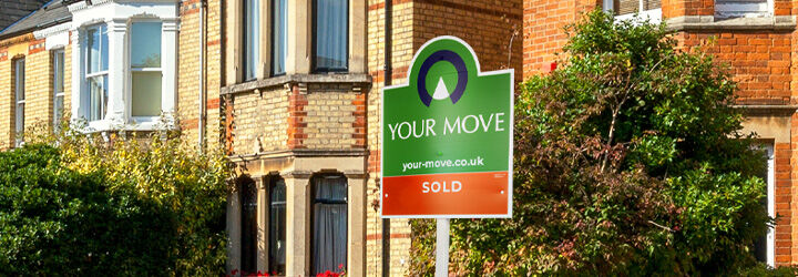 A Your Move 'Sold' board outside a house in the morning sun