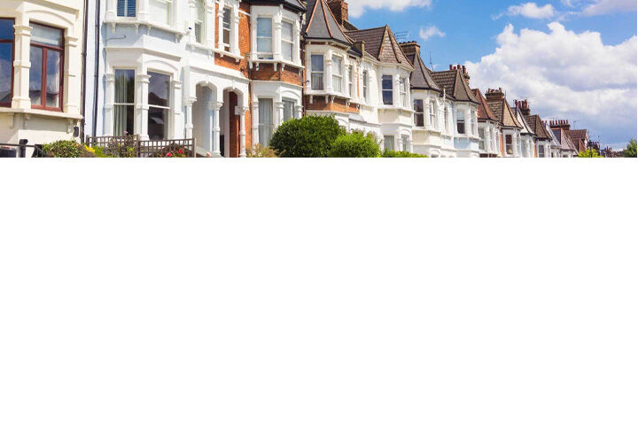 Row of traditional terraced houses beneath a blue sky