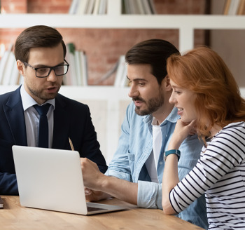 A letting agent showing landlords a laptop